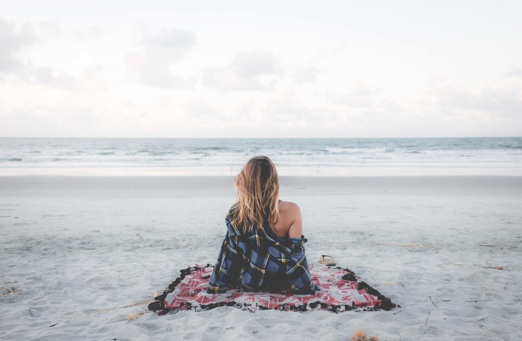 A woman staring out into the ocean