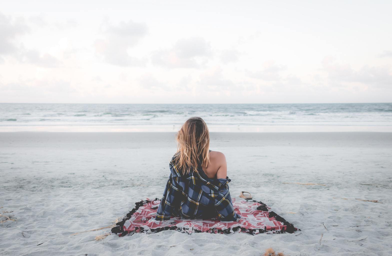A woman staring out into the ocean